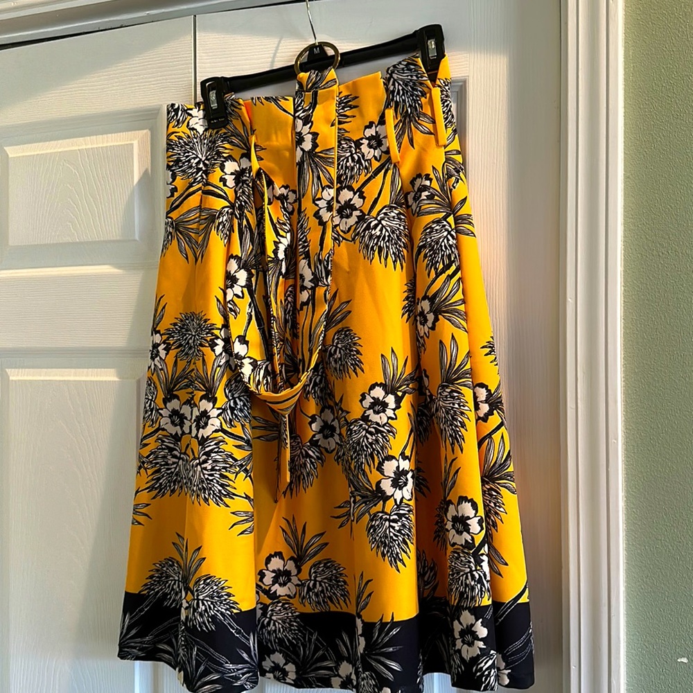 Size small women’s skirt. Yellow with blue and white floral pattern.